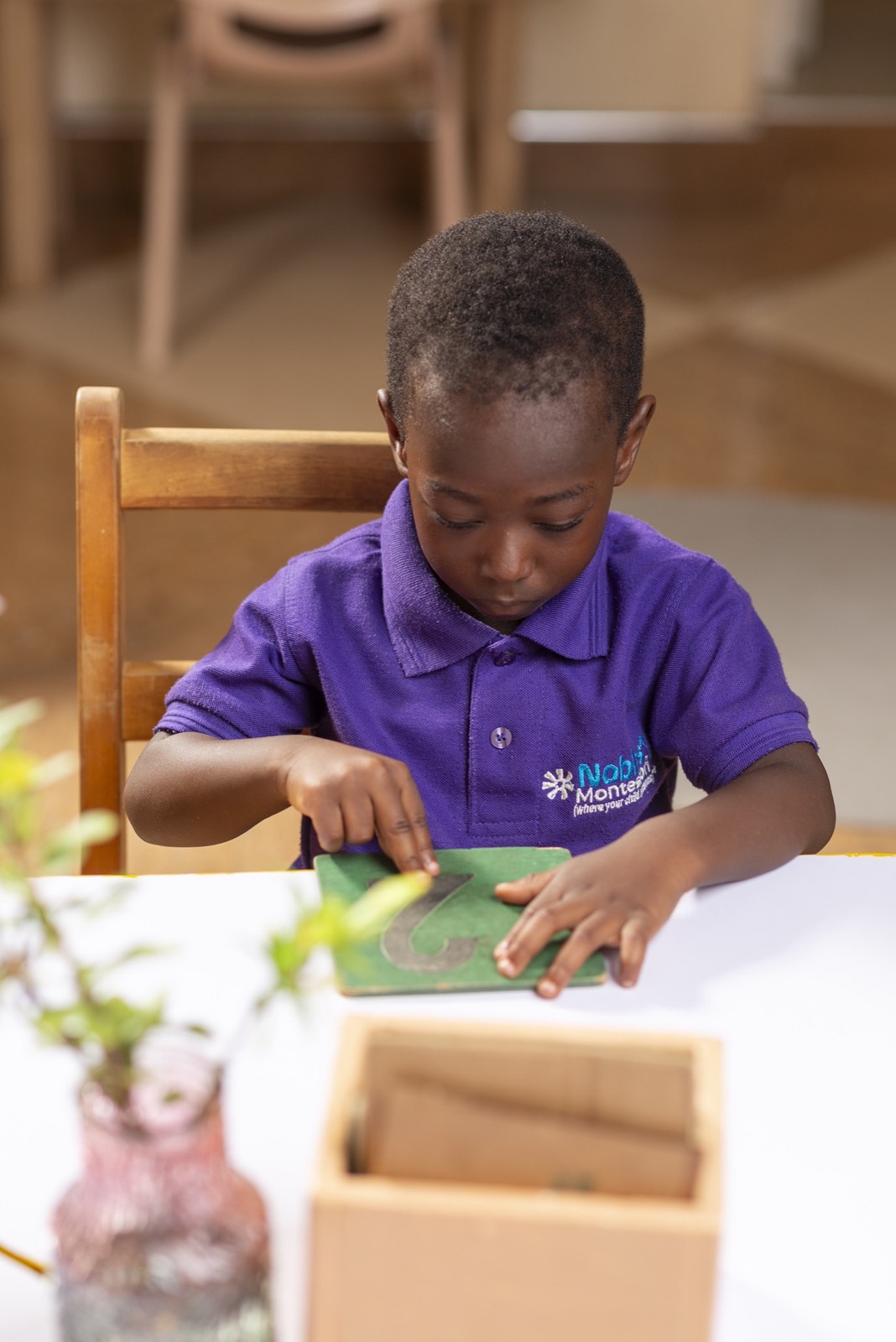 A Children's House child practising early writing